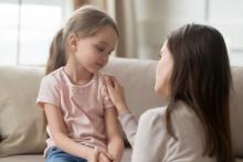 Mom showing support to young daughter.